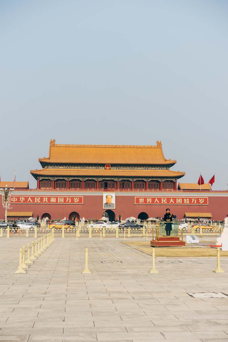 china people walking on red and brown temple during daytime peking