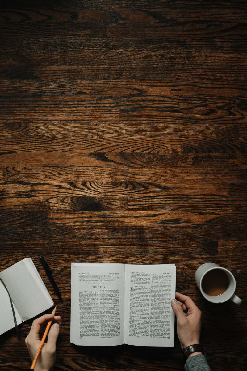 study person sitting by the table opening book table