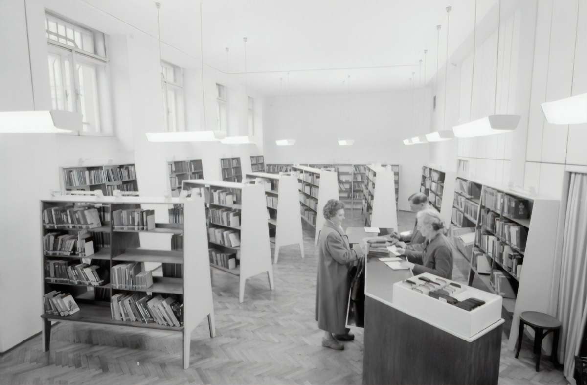 grey grayscale photography of people inside book store economy