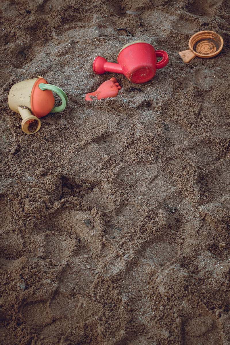 germany two yellow and red plastic watering cans on seashore erlangen