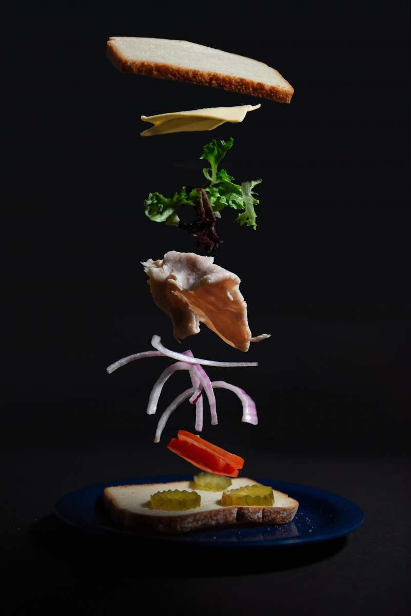 slowmotion vegetable sandwitch on blue plate studio photography
