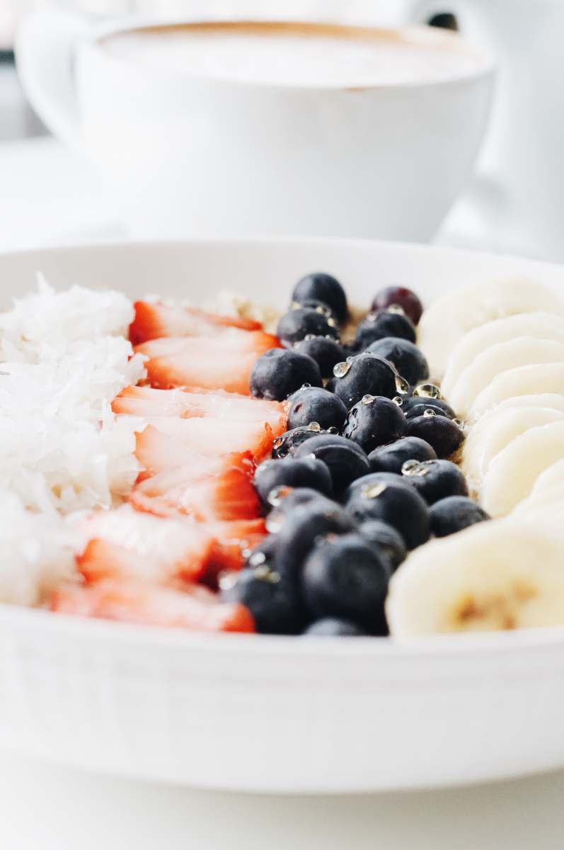 foodie white cream with black berries on white ceramic bowl berries