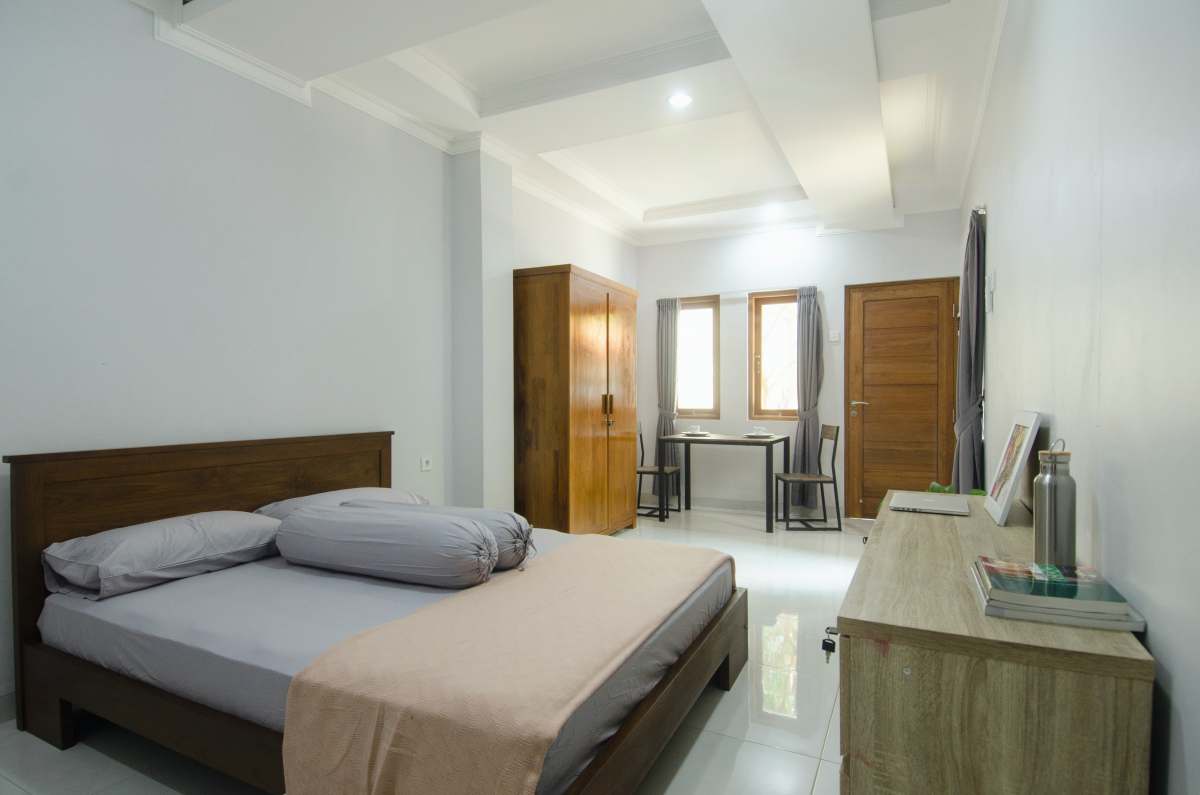 indoors white bed linen on bed room