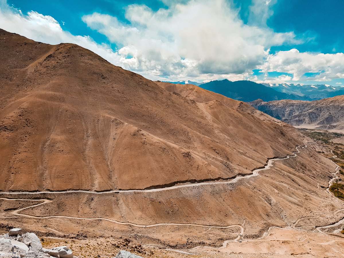 ladakh brown mountain under blue sky during daytime empty road