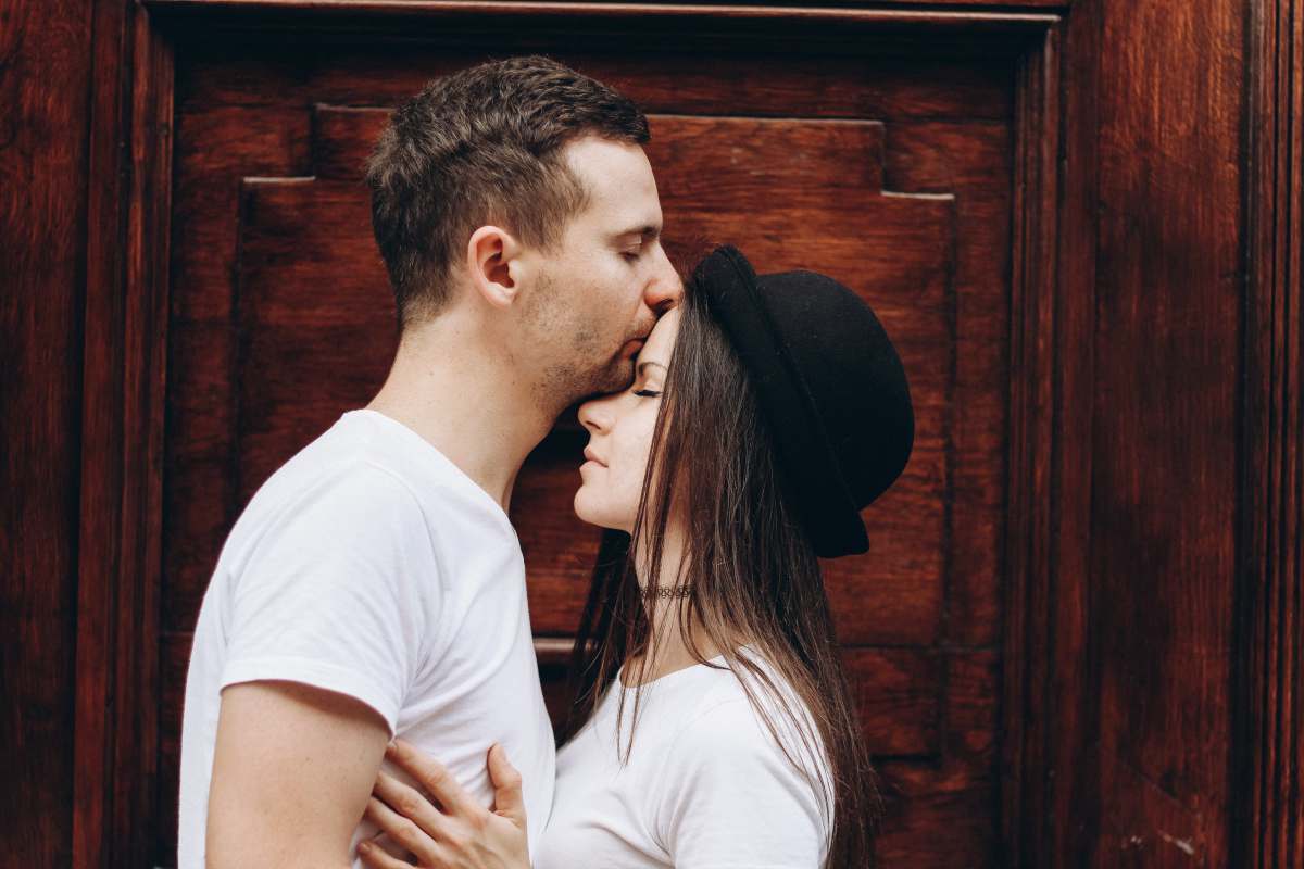 sweetheart man kissing woman forehead relationship