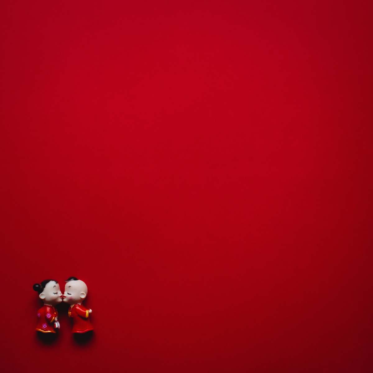 kiss girl and boy wearing red dress figurines valentines day