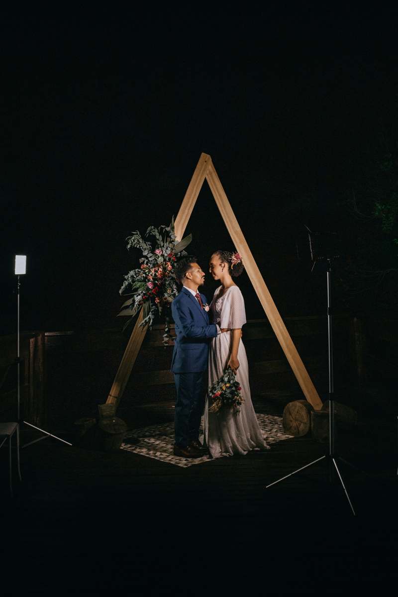 wedding man in blue dress shirt and brown pants sitting on brown wooden ladder amor