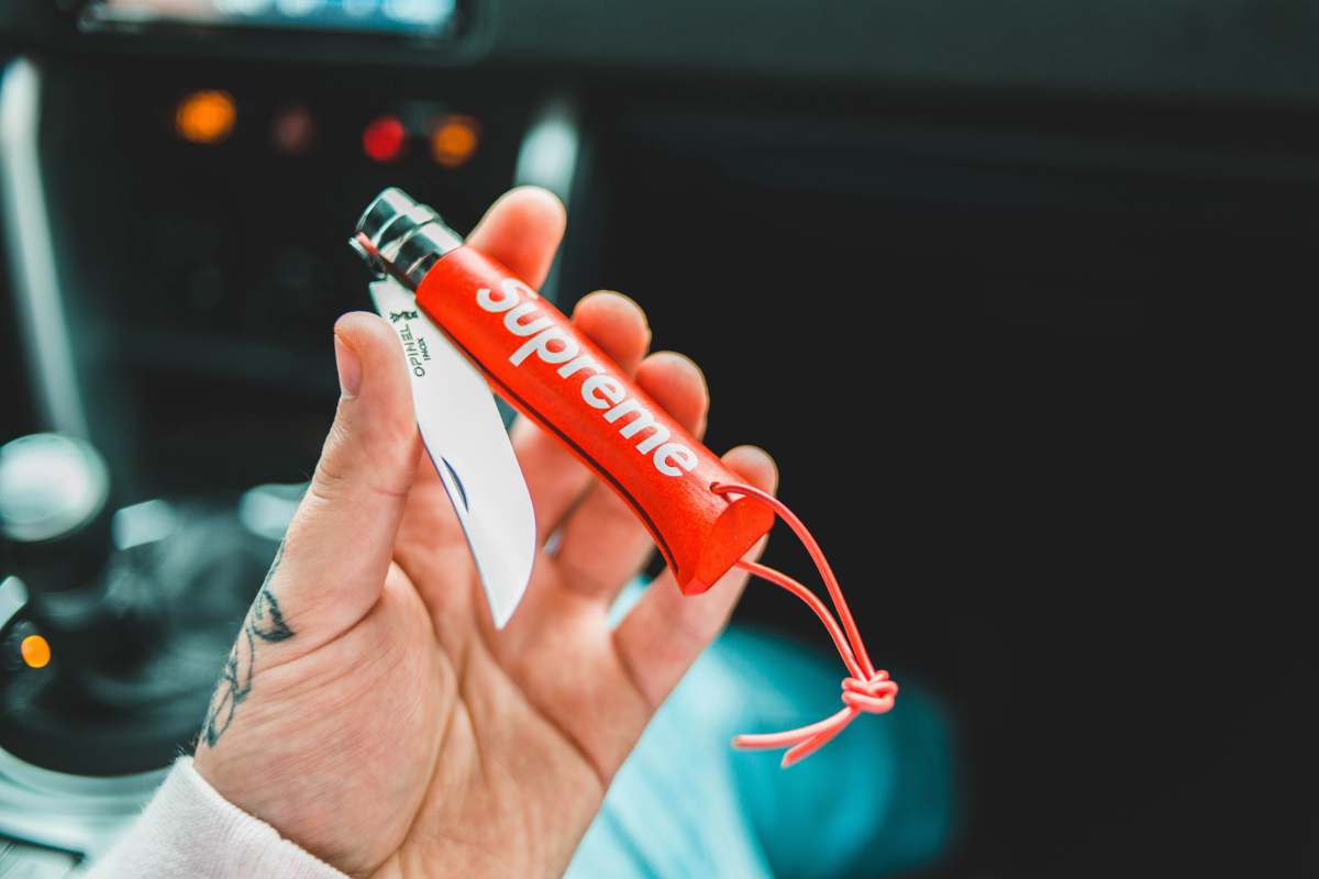 human person holding red and white plastic tube weaponry