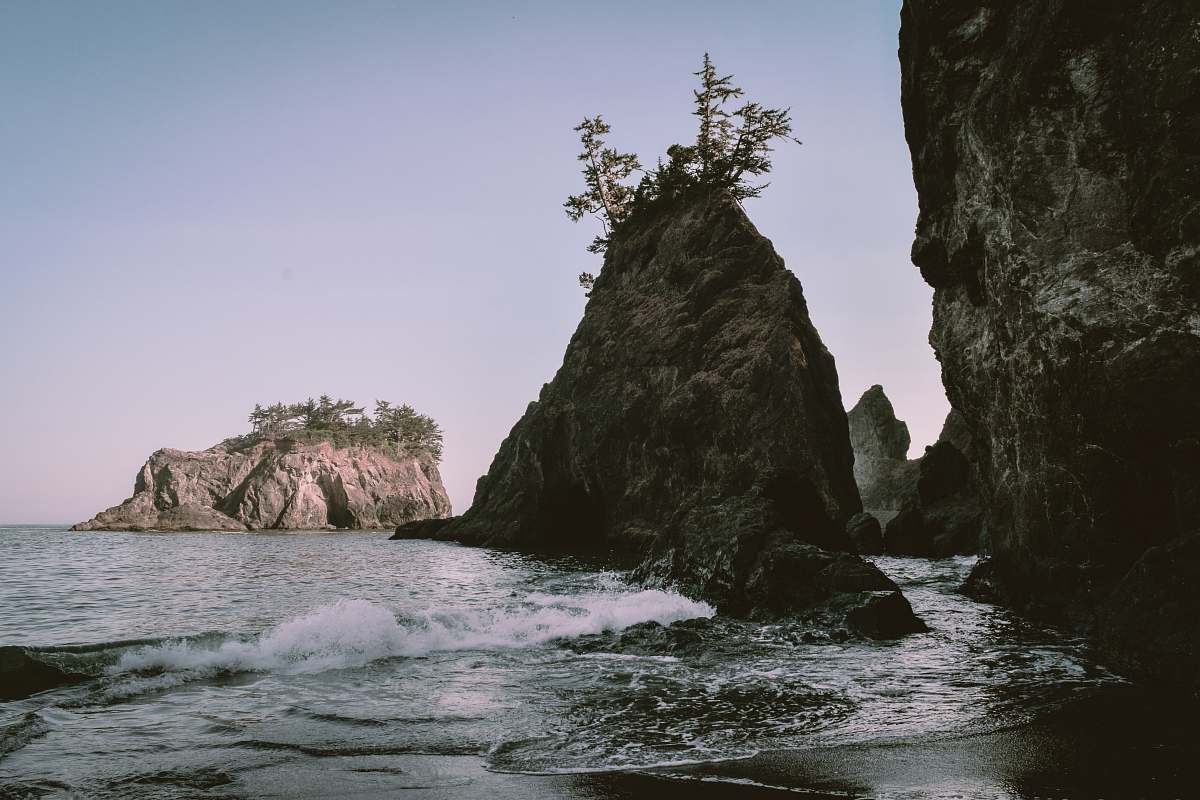 water brown rock formation on sea water during daytime ocean