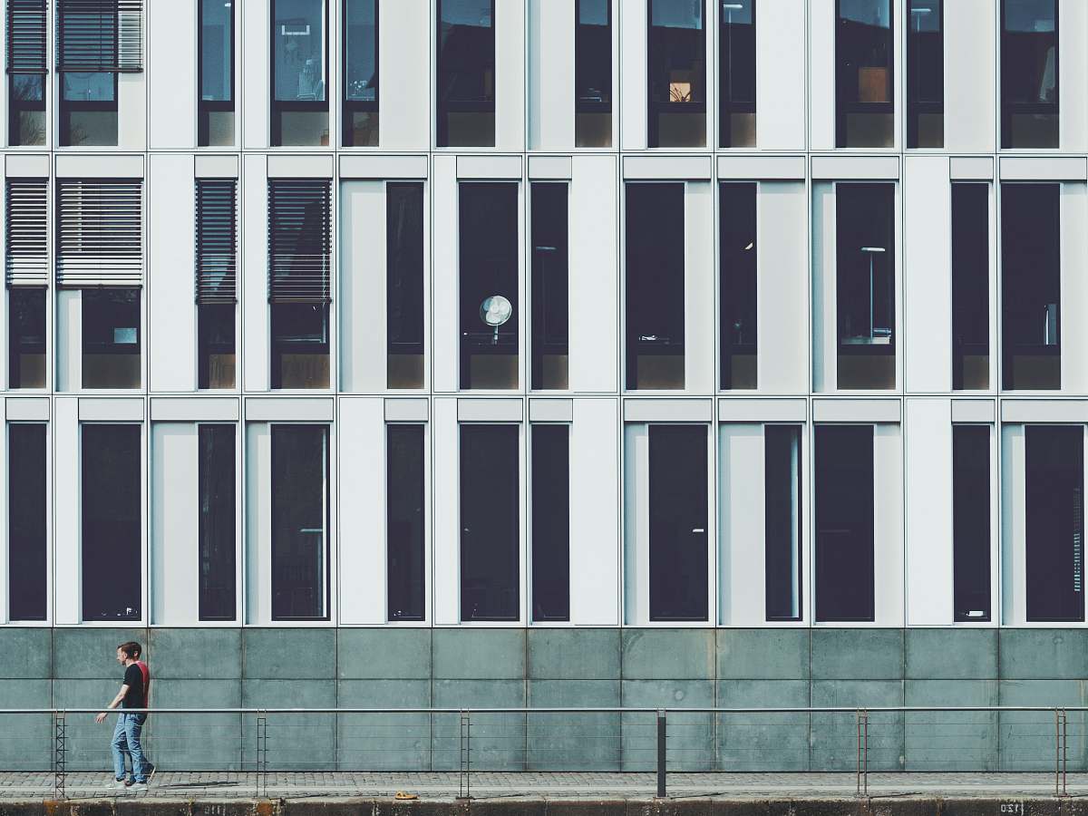  two men walking beside building 
