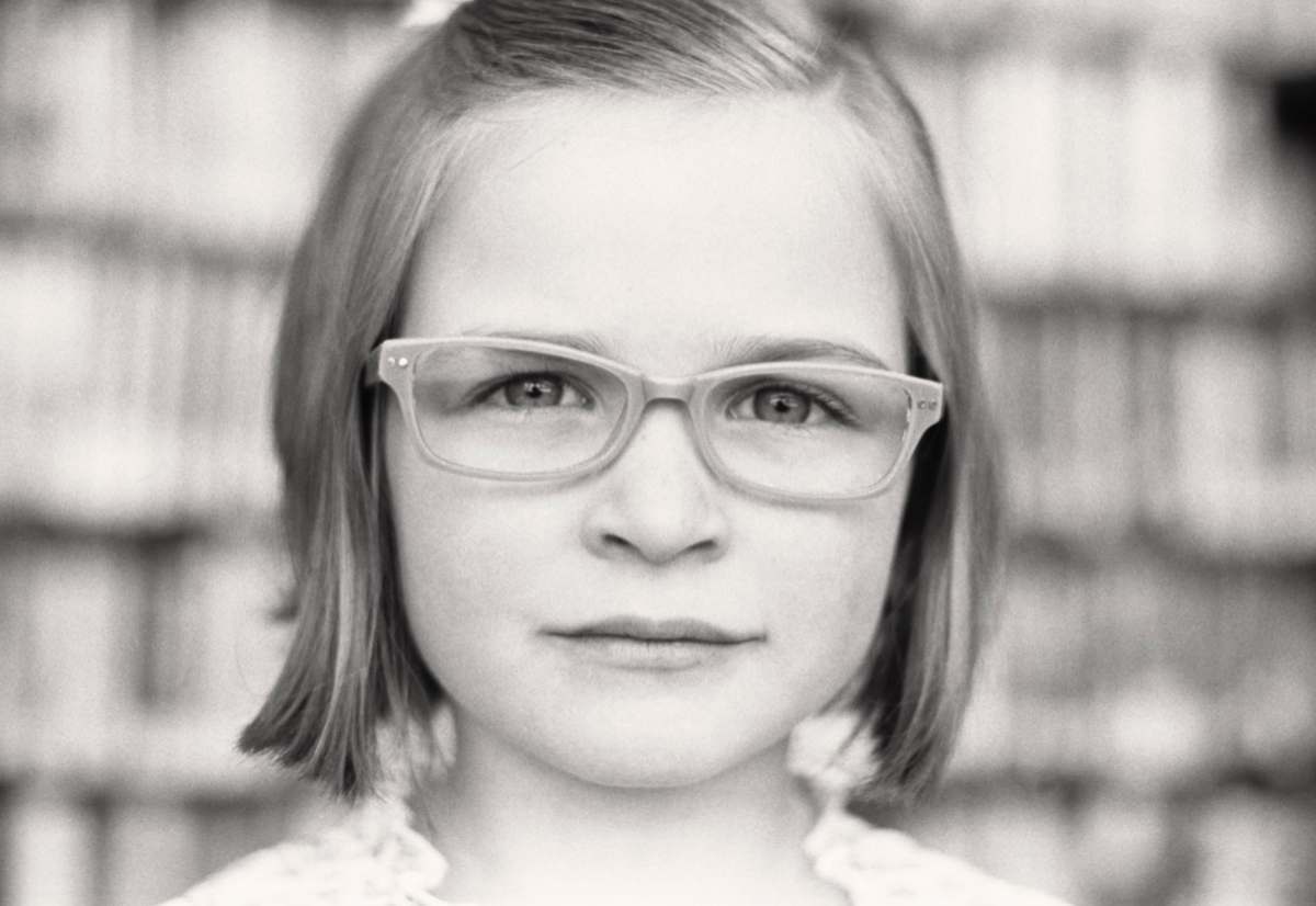 logan grayscale photo of girl wearing eyeglasses utah