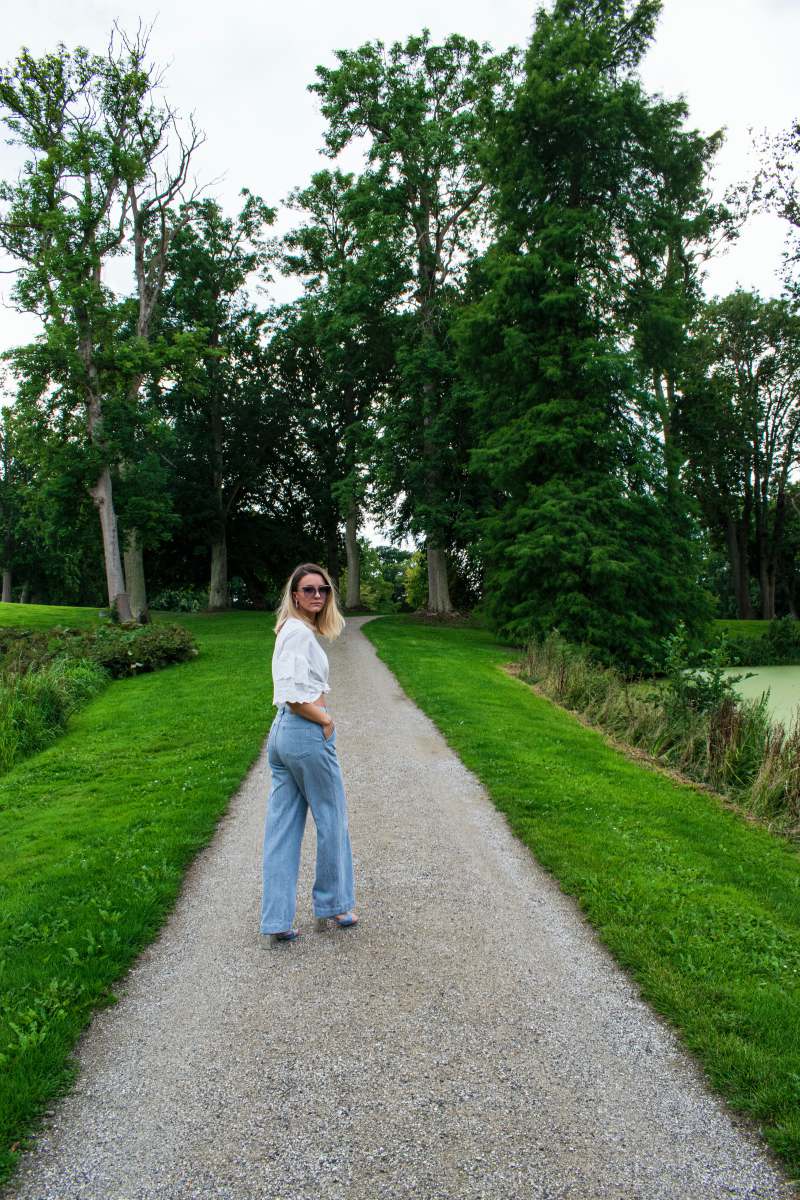 Denmark Woman In White Long Sleeve Shirt And Blue Denim Jeans Standing ...