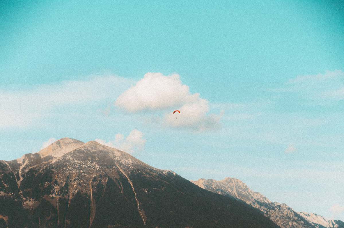  white clouds over brown and green mountain 