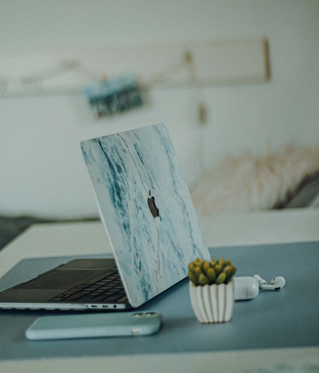  silver macbook on white table 