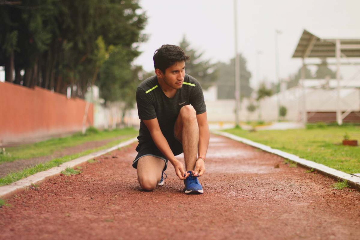 mexique man in black t-shirt and black shorts sitting on brown dirt road during daytime sport