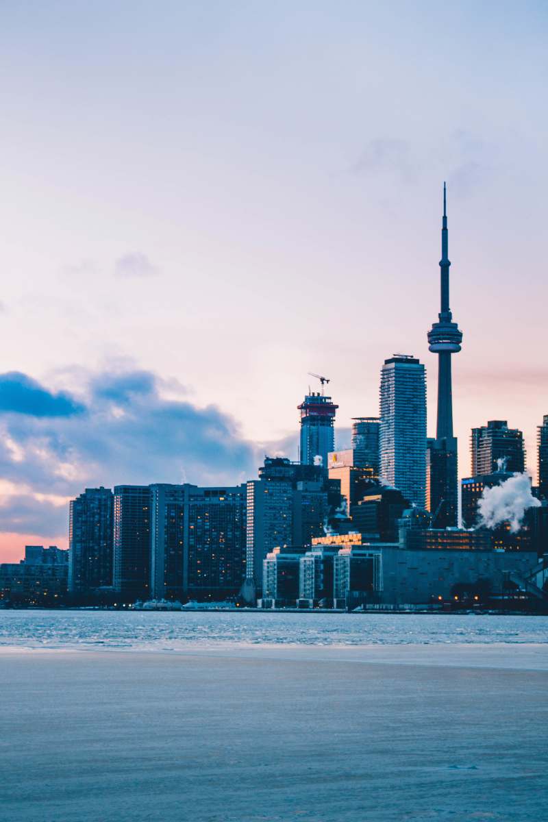 Capture the breathtaking beauty of Toronto's skyline at dusk, featuring the iconic CN Tower gracefully towering in the background. This vibrant cityscape showcases a blend of modern architecture and natural beauty, making it perfect for travel articles, city guides, or promotional materials. Whether you're looking to highlight urban landscapes or Canadian landmarks, this image encapsulates the essence of Toronto.