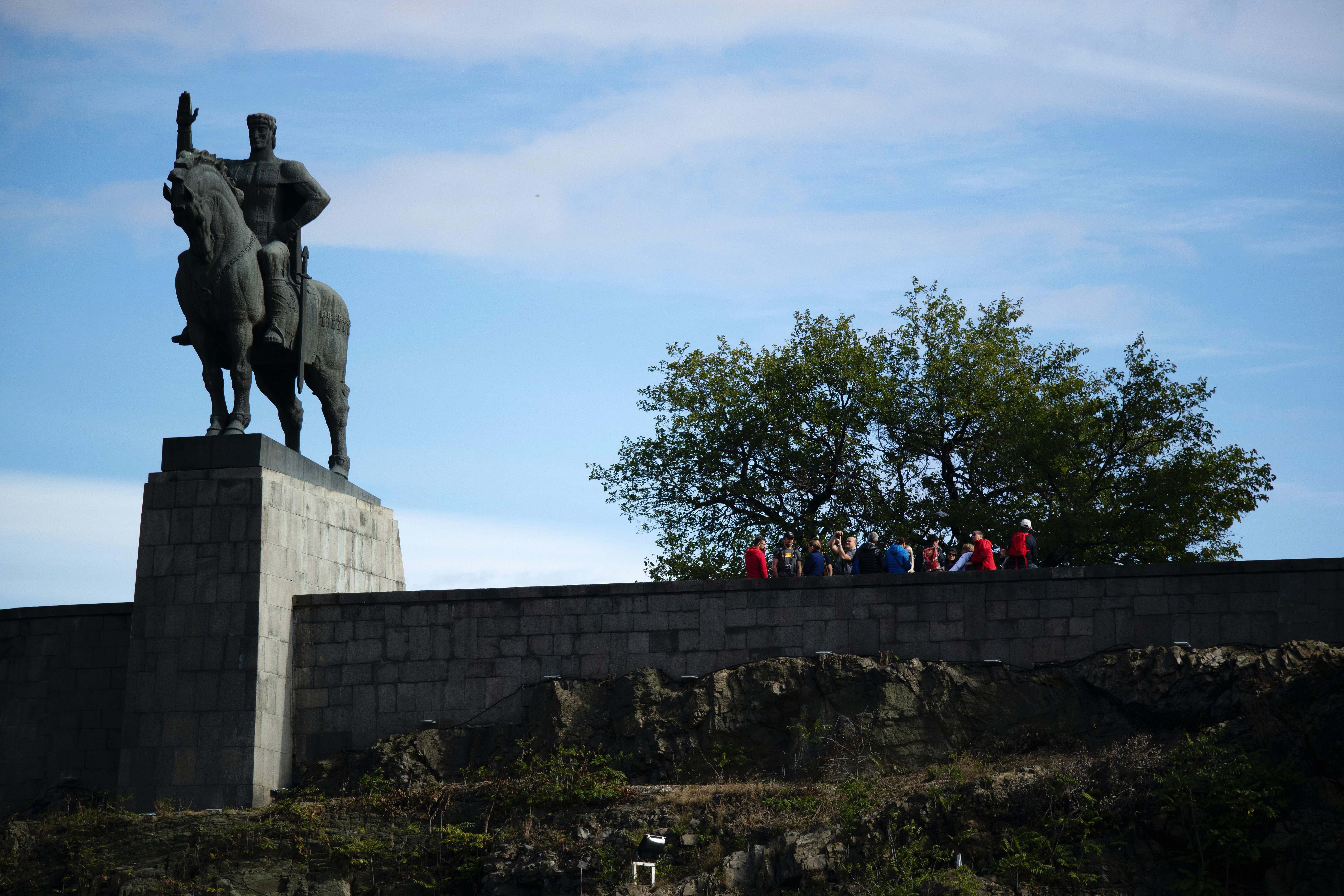 Georgia People Walking Near Green Tree Beside Man Riding Horse Statue 