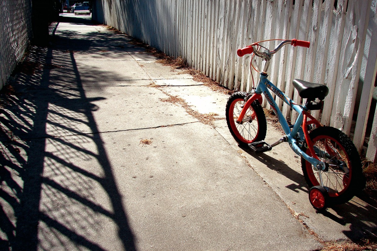 bicycle with training wheels sidewalk shadows cano bf86d358 3c0b 4e83