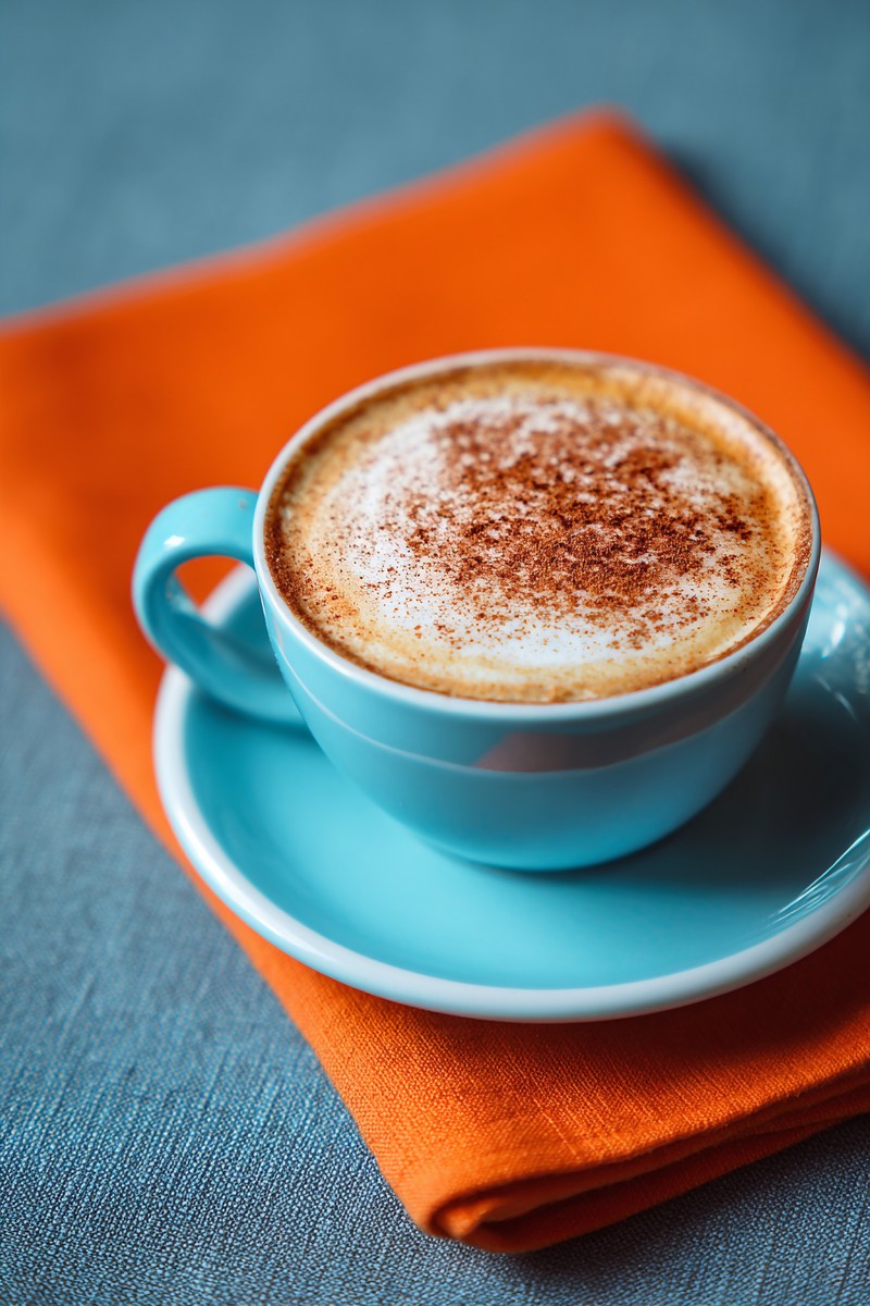 cappuccino with cinnamon sky blue cup orange