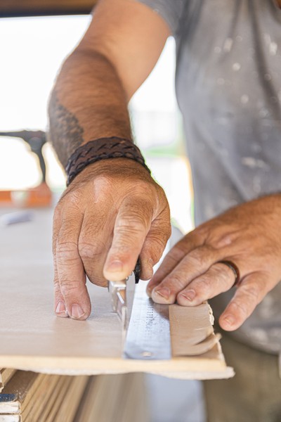 Drywall Installation Process with Worker Cutting Panel