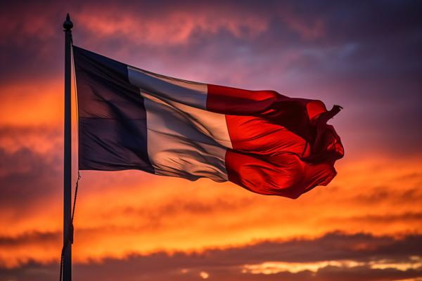 The French flag gracefully fluttering against a colorful sunset
