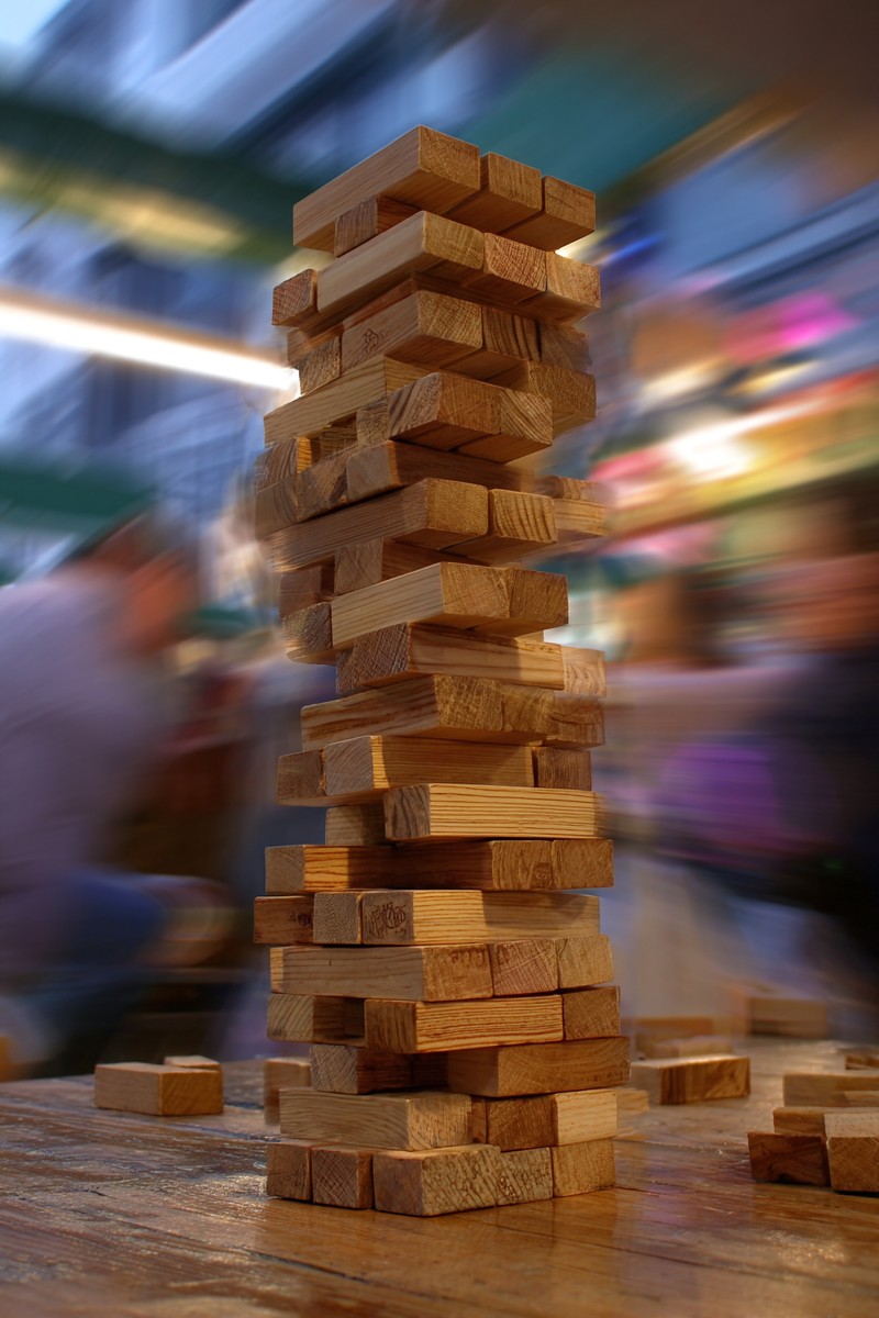 jenga tower collapsing laughter blur background 5ed173e4 ffc6 4aba bd94