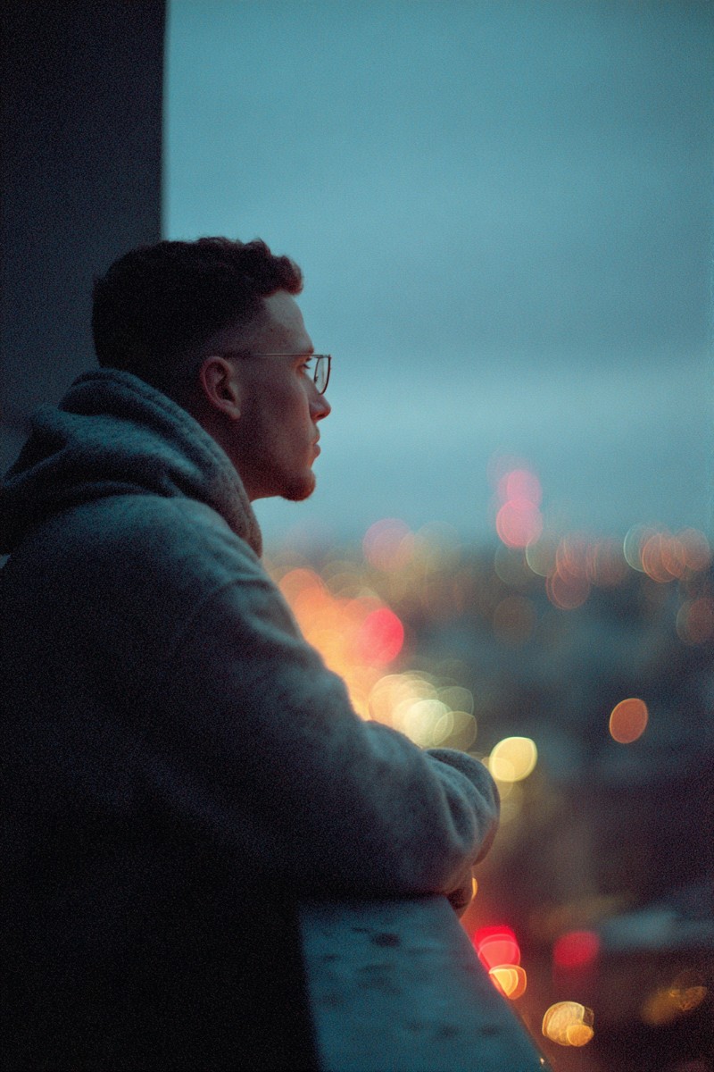 melancholy moments man looking out from balcony 0a89b0bc 94a6 4835
