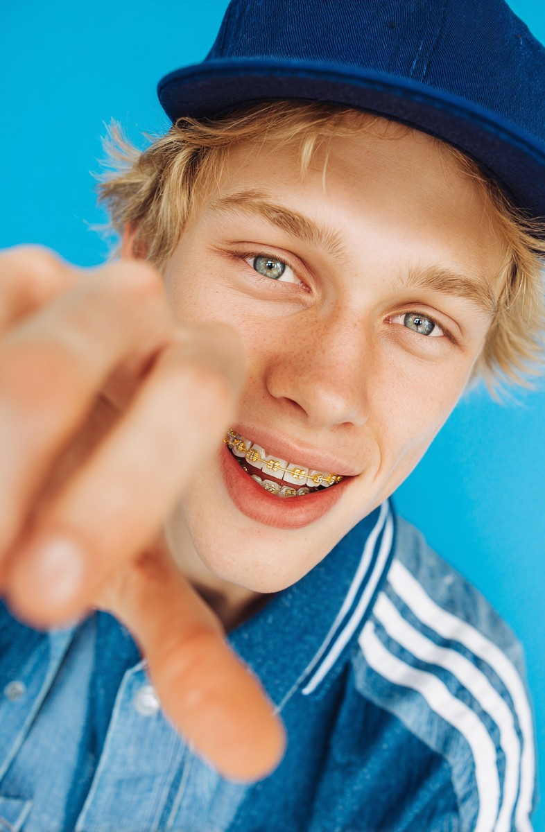 photo young man holding his braces with his 0cad87cd 8513