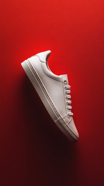 White Sneaker on Solid Red Background