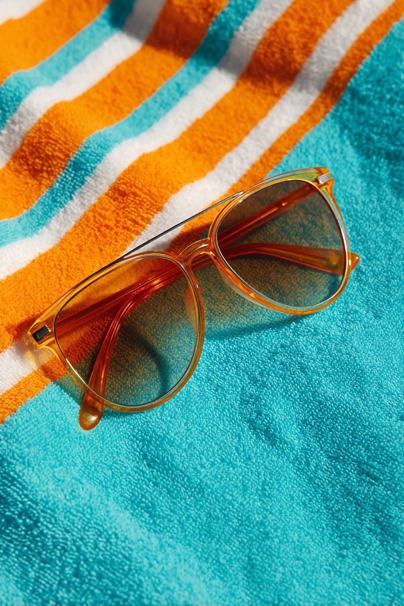 sunglasses with orange lenses turquoise beach
