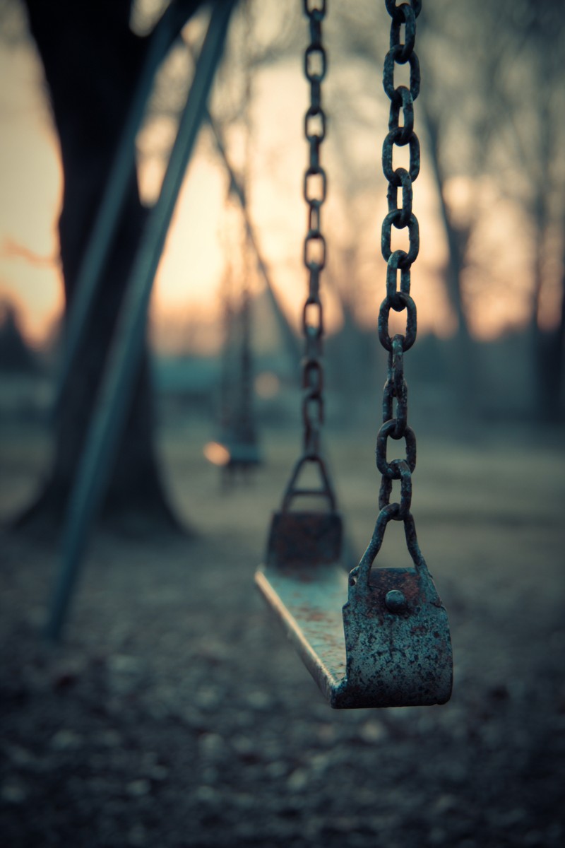 swing set empty dusk blurry background trees f1f9c7ef 15c8 4477