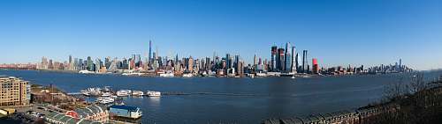 scenery city skyline across body of water during daytime panoramic