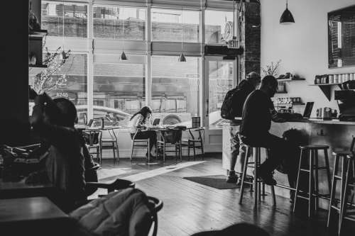 seattle grayscale photo of people sitting on chair wa