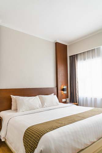 bed black sconce beside white bed indoors
