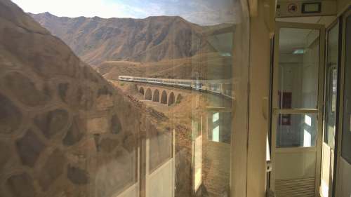 train white concrete house near mountain bridge