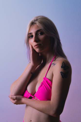 on woman in pink brassiere with left arm on her head canada