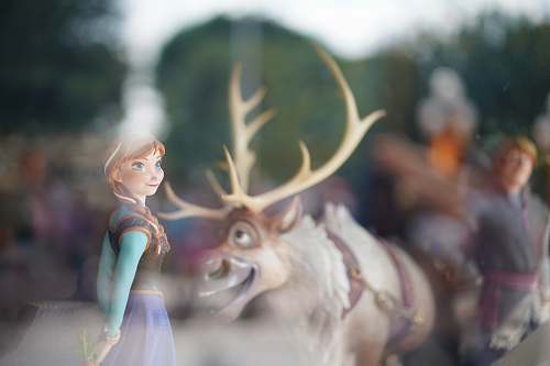 grey Disney Frozen characters behind glass panel doll