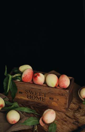 fruit peaches in brown wooden box wellness