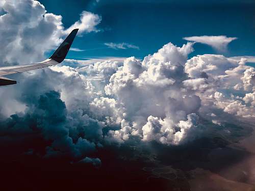 cloud high angle photography of airliner's right wing sky
