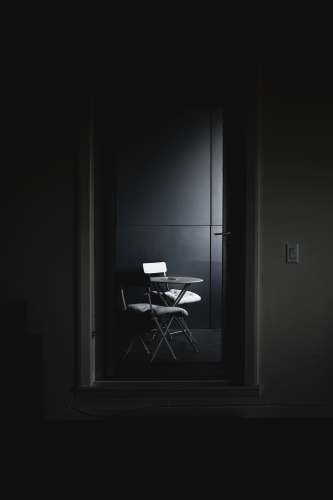 grey black and white chair beside white wall chair