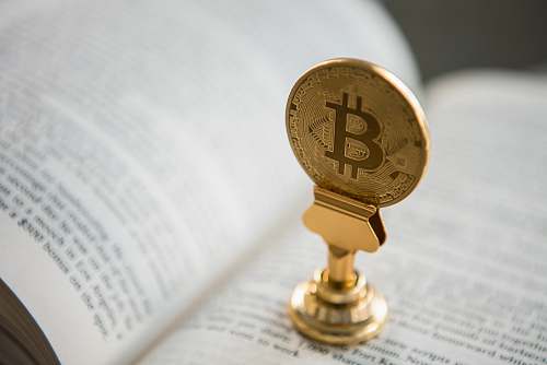 toronto bitcoin on gold stand on top of book canada