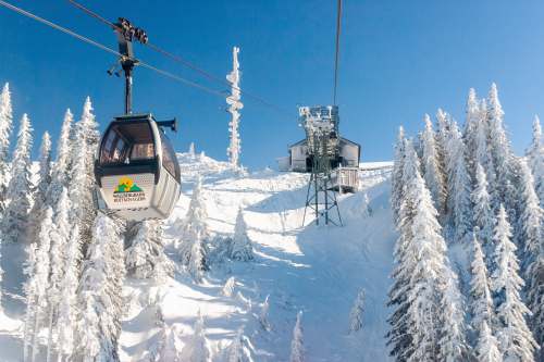 blue white and black cable car over snow covered mountain during daytime rottach-egern