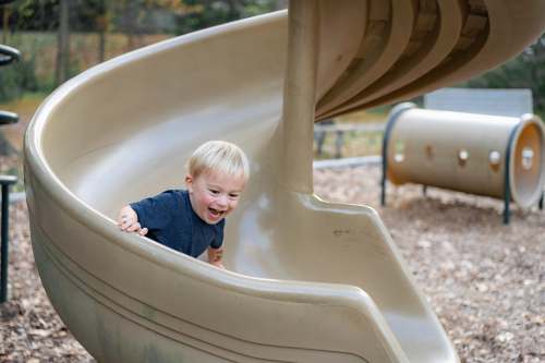 playground boy in blue shirt in white bathtub happy child