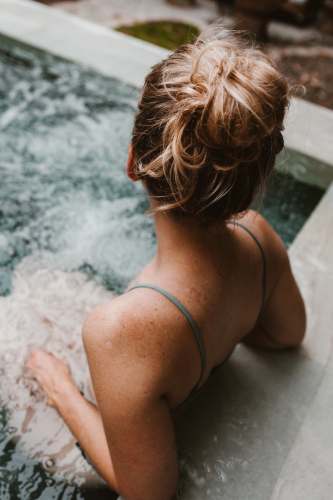 wellness woman in hot tub spa