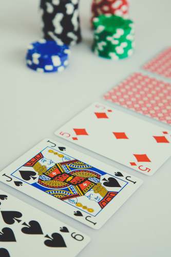 gambling assorted playing cards on white surface felt