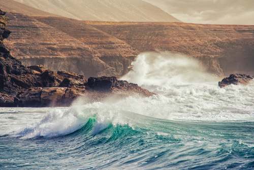 sea big waves crashing coastal rock during daytime grey