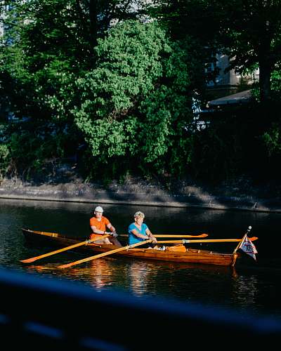 human man and woman rowing in boat person