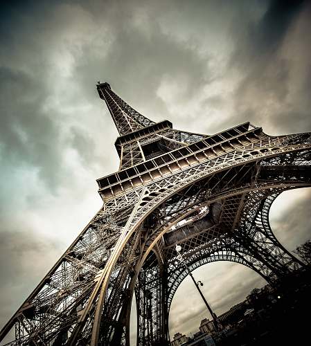 building eiffel tower under gray cloudy sky architecture