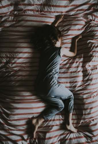girl woman lying on gray and red striped textile kid