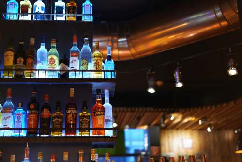 salzburg assorted-title glass bottle lot on black metal rack austria